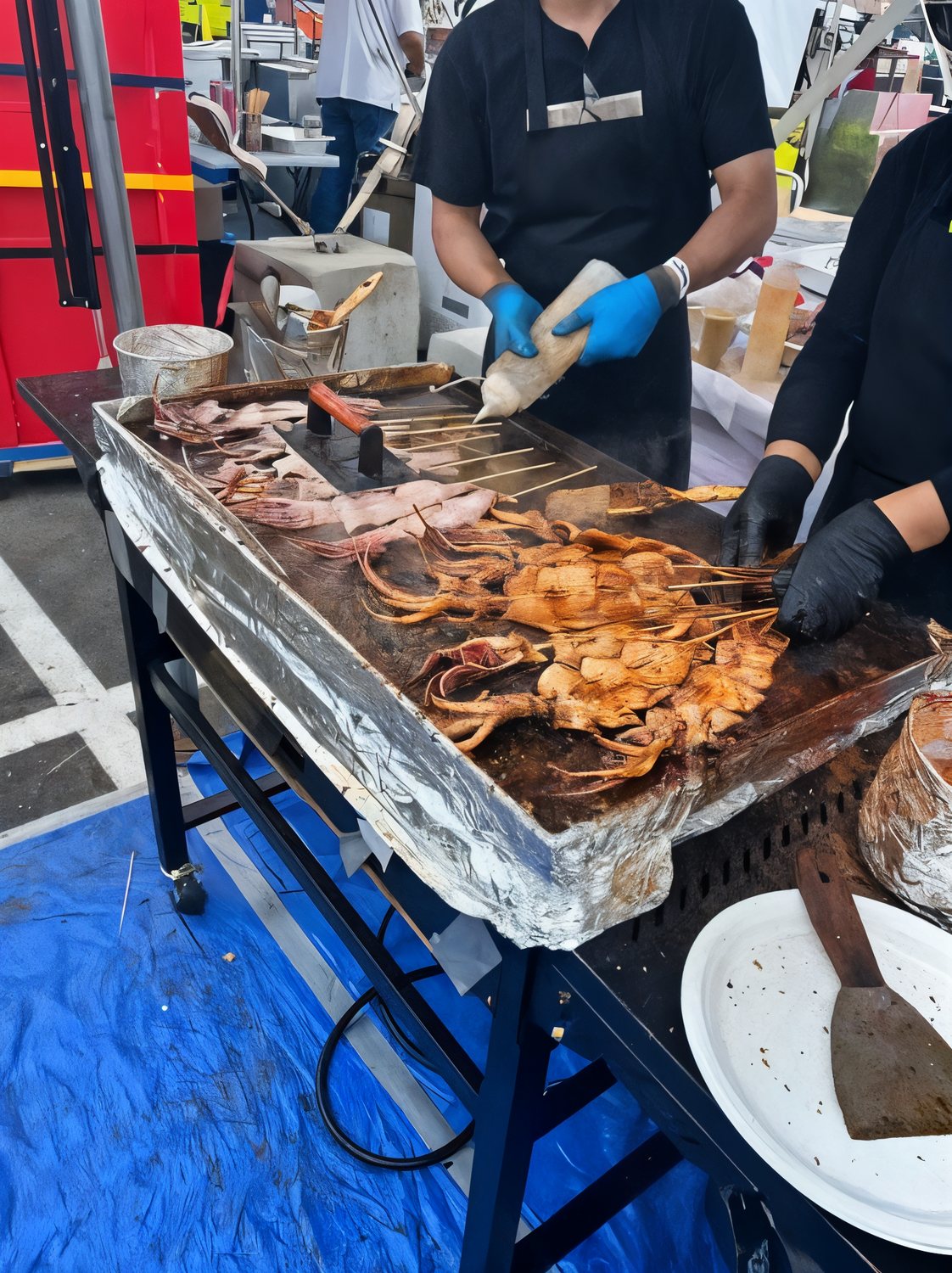 Grilled squid on the flat-top griddle at a Chen's BBQ pop-up service